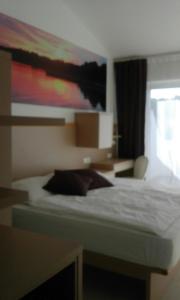 Postel nebo postele na pokoji v ubytování Jurman Apartment