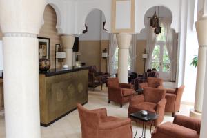 a lobby with chairs and a waiting room at Riad des Golfs in Agadir