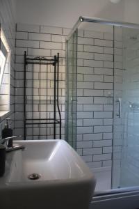 a bathroom with a tub and a glass shower at Apartman Luka in Viganj +5 photos