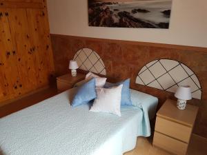 ガルダーにあるPunta de Galdar Nature and Confortのベッドルーム1室(ベッド2台、青と白の枕付)