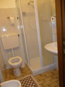 a bathroom with a shower and a toilet and a sink at Hotel San Giovanni in Milan +48 photos