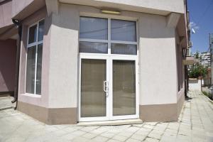 a white door on a building with windows at Studio Toni in Sliven