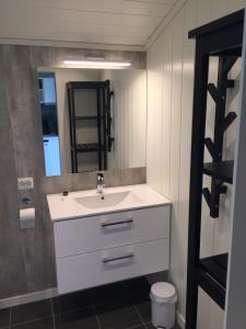 a bathroom with a sink and a mirror at Dalen Gaard camping og hytter in Geiranger +21 photos