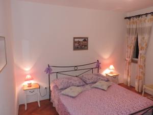 1 dormitorio con 1 cama rosa y 2 lámparas en Apartment Pera, en Split