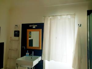 a bathroom with a white shower curtain and a sink at Dimora Montalto,indipendente con terrazzo privato in Syracuse +34 photos