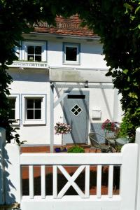 a white bench in front of a white house at Ferienhaus Landhaus Am Hirtzborn in Marburg an der Lahn