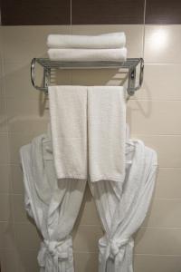 a towel rack with white towels on it in a bathroom at Hotel VERA in Yekaterinburg