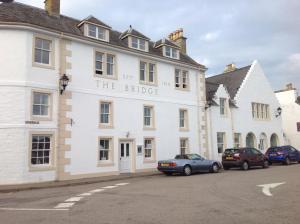 a white building with the bridge written on it at The Bridge Helmsdale in Helmsdale