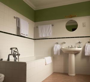 a bathroom with a sink and a bath tub and a sink at The Bridge Helmsdale in Helmsdale