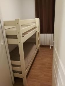 a bunk bed in a room next to a door at Before Sunrise in Super Besse