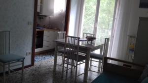 a kitchen with a table and chairs and a window at Casarcobaleno in Trieste