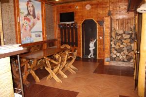 a dining room with a table and chairs and a fireplace at Complex Mriya in Yaremche