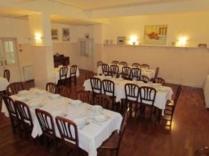 a room full of tables and chairs with white tablecloths at Sao Tomas in Fátima