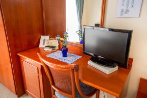 a desk with a computer monitor on top of it at Hotel Mediterraneo in Cefalù