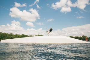 a person on a large ramp in the water at Camping Pod in Zarasai