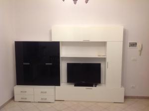 a large white entertainment center with a flat screen tv at Appartamento al mare Puglia in Ginosa Marina