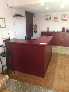 a red reception desk in a room at Hostal L'Escaleta in Oropesa del Mar