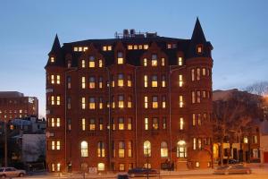 a large brick building with its lights on at Hotel Brexton, Trademark Collection by Wyndham in Baltimore