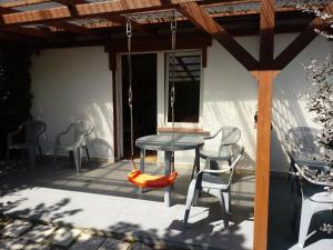 a patio with a table and chairs on a porch at Domki Elżbieta in Swarzewo
