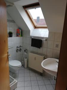 a bathroom with a toilet and a sink at Fa Haack in Neuried