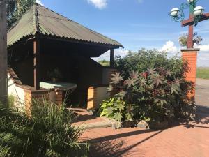 a small building with a bench in a garden at Khorol-1 Motel in Khorol