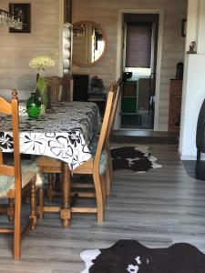 a dining room with a table and a table and chairs at Bondegårdsparken Farm Holiday in Kristiansand