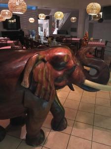 a statue of an elephant in a restaurant at Hotel Paradiso in Hikkaduwa