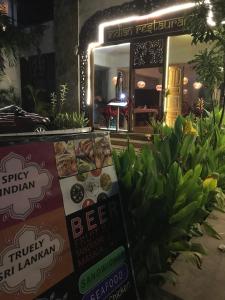 a sign in front of a beer restaurant at Hotel Paradiso in Hikkaduwa