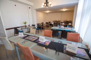 a dining room with tables and chairs with signs on them at Népliget Hotel in Budapest +54 photos