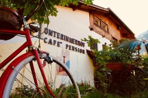 a red bike parked in front of a building at Panoramahotel Unterinnerhof in Auna di Sotto