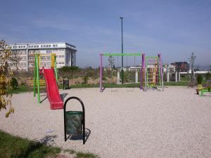 a playground with colorful play equipment in a park at Olad Riverview Townhouse in Sarajevo