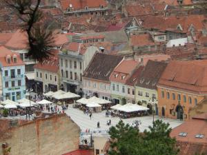 a view of a city with people walking in the street at 4 Rooms Piata Sfatului in Braşov