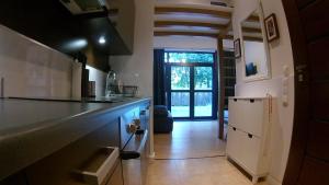 a kitchen with a counter and a hallway with a door at DUNE Apartments in Mielno