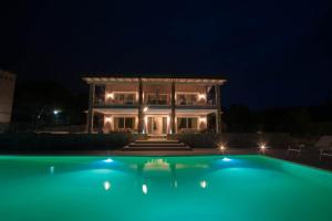 a house at night with a swimming pool in front at Italianflat - Maison du Lac in Lazise