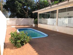 a swimming pool in the backyard of a house at Casa Aconchego Fóz in Foz do Iguaçu