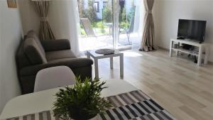 TV a/nebo společenská místnost v ubytování Tauralaukio g. 24B apartamentai
