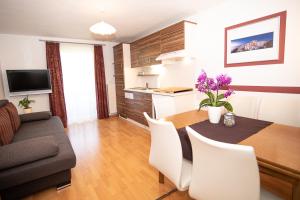 a kitchen and living room with a table and chairs at Appartement Haus Moser in Sankt Michael im Lungau