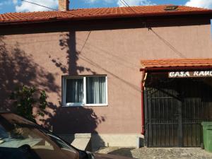 a building with a window and a sign on it at Casa Raul in Coramnic