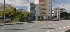 an empty street in a city with a building at Duplex Makishi in Makishimachi