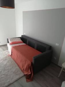 a bedroom with a bed with a red blanket at La Casetta della letizia in Colle