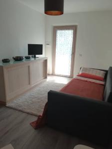 a living room with a bed and a television at La Casetta della letizia in Colle