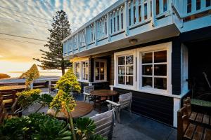 a house with a patio with a table and chairs at Kaikoura Boutique Hotel in Kaikoura