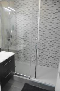 a shower with a glass door in a bathroom at Disney & Family Shopping, 10 minutes Disneyland! in Serris +27 photos