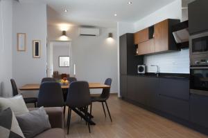 a kitchen and dining room with a table and chairs at Luxury Poolside Villa in Slatine