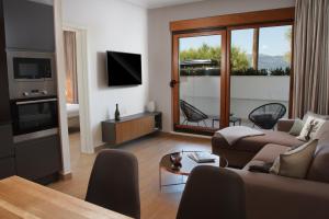a living room with a couch and a tv at Luxury Poolside Villa in Slatine