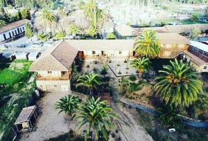 an aerial view of a house with palm trees at Hotel Parador Vichuquen in Vichuquén