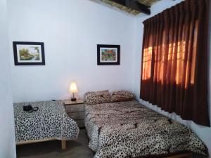 a bedroom with two beds and a window at Pousada Villa Huaripampa in Jauja +75 photos