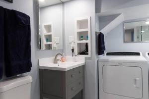 a bathroom with a sink and a washing machine at Luxury 2 bedroom apartment w/ free parking in Washington