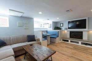 a living room with a couch and a tv and a table at Luxury 2 bedroom apartment w/ free parking in Washington, D.C.