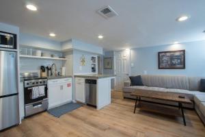 a kitchen and living room with a couch and a table at Luxury 2 bedroom apartment w/ free parking in Washington, D.C.